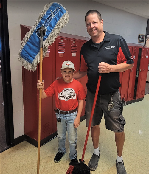 Hilltop third grader Isaac Moy with custodian Troy Schliinz